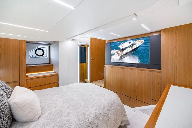 Slide: The Image of Luxurious 2025 Tiara Yachts EX 54 bedroom with modern wood finishes and large TV. - 40