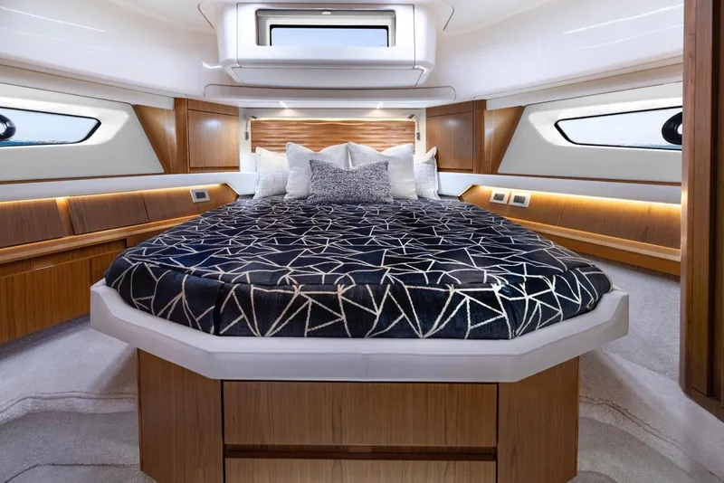Slide: The Image of Luxurious 2025 Tiara Yachts EX 54 bedroom with modern design and elegant bedding. - 42