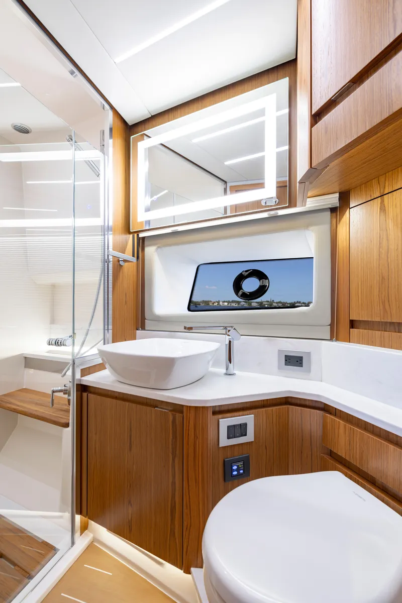 Slide: The Image of Luxurious bathroom in 2025 Tiara Yachts EX 54, featuring modern fixtures and elegant wood finishes. - 45