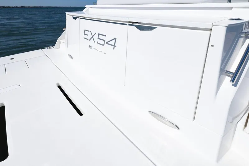 Slide: The Image of 2025 Tiara Yachts EX 54 luxury yacht on calm water. - 7
