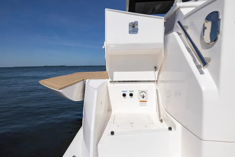 Slide: The Image of 2025 Tiara Yachts EX 54, sleek deck design with ocean backdrop. - 8