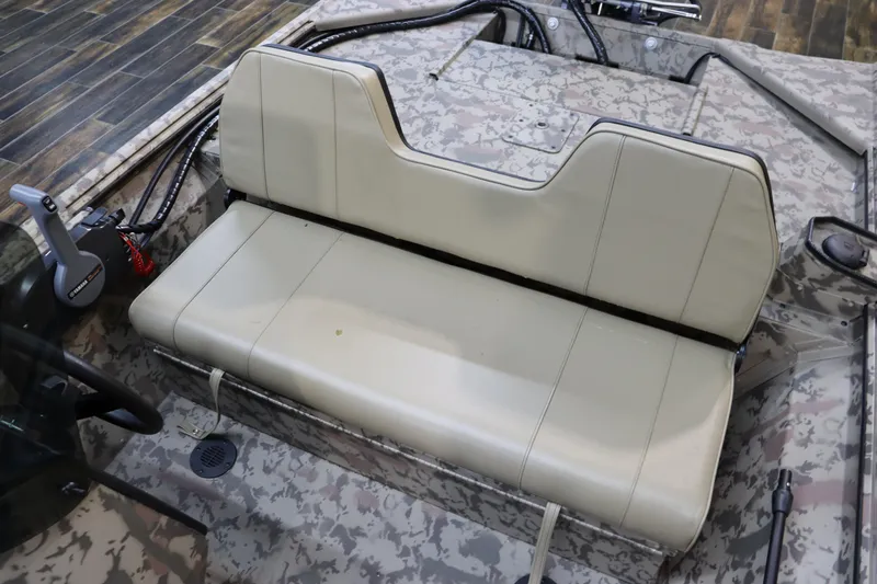 Slide: The Image of 2025 War Eagle 648LDSV boat interior with camouflage design and beige seating. - 10