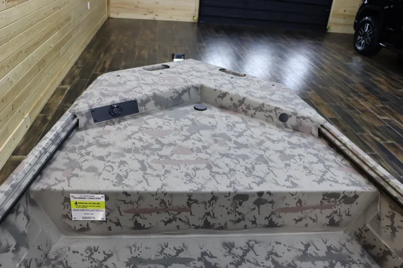 Slide: The Image of 2025 War Eagle 648LDSV boat interior with camouflage design in a wooden-floored showroom. - 17