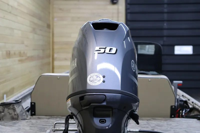 Slide: The Image of 2025 War Eagle 648LDSV boat with Yamaha 50HP outboard motor in a wooden garage. - 4