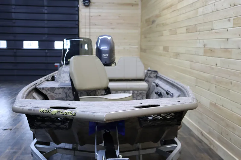 Slide: The Image of 2025 War Eagle 648LDSV boat in wooden interior garage setting. - 7