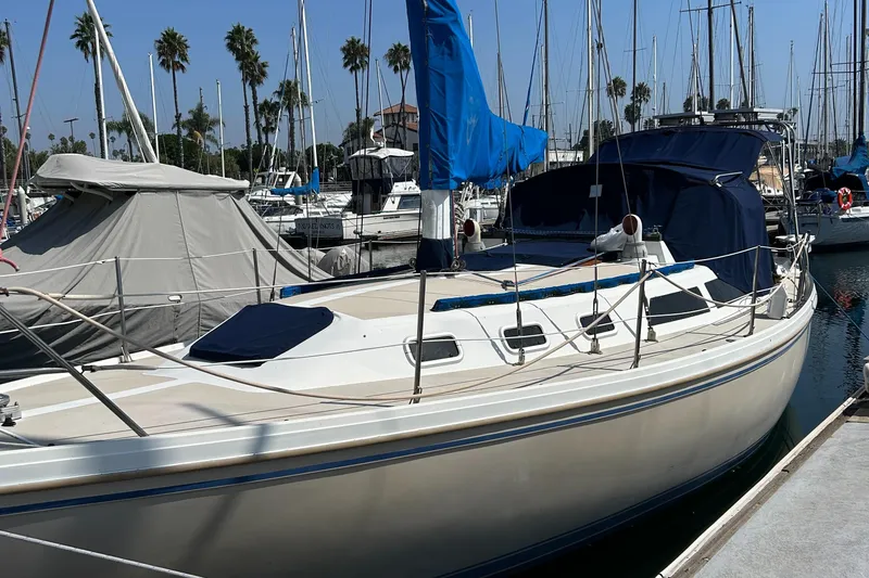 The Image of 1988 Catalina mrk.1 sailboat docked in marina with blue sail cover. - 0