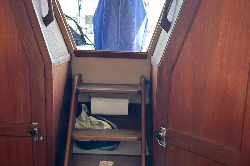 Slide: The Image of Interior of 1988 Catalina mrk.1 sailboat with wooden steps and storage compartments. - 10