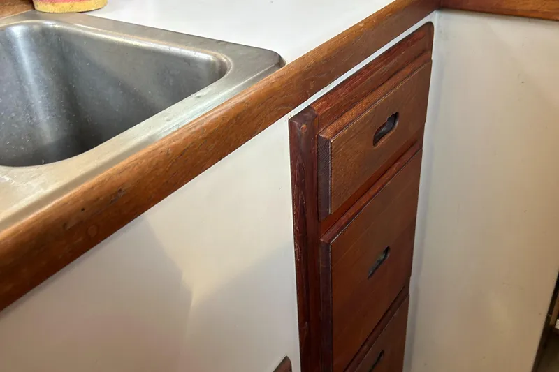 Slide: The Image of 1988 Catalina mrk.1 kitchen with wooden cabinets and stainless steel sink. - 8