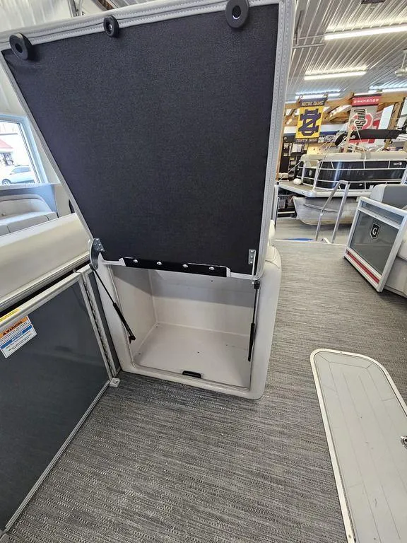 Slide: The Image of 2025 Godfrey Sweetwater 2286 SFL boat interior with open storage compartment. - 11