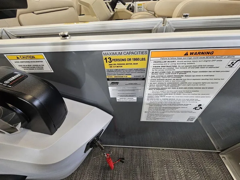 Slide: The Image of Capacity and warning labels on 2025 Godfrey Sweetwater 2286 SFL GTP boat interior. - 14