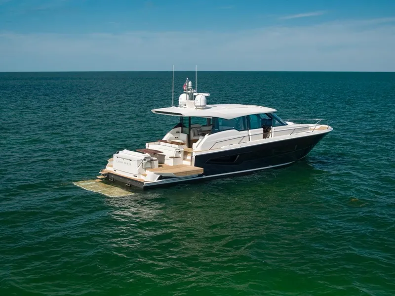 Slide: The Image of 2025 Tiara Yachts EX 60 luxury yacht cruising on open sea. - 11