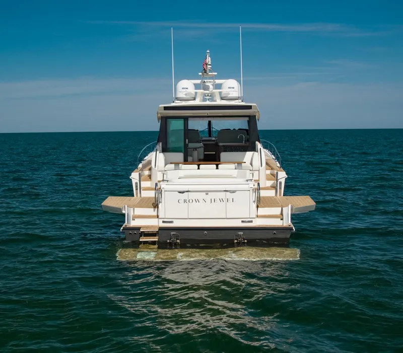Slide: The Image of 2025 Tiara Yachts EX 60 on open water, rear view, clear sky. - 12