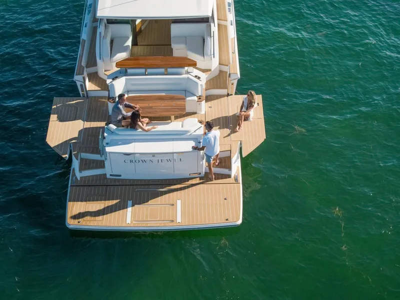 Slide: The Image of Aerial view of 2025 Tiara Yachts EX 60 on water, featuring spacious deck and seating. - 15