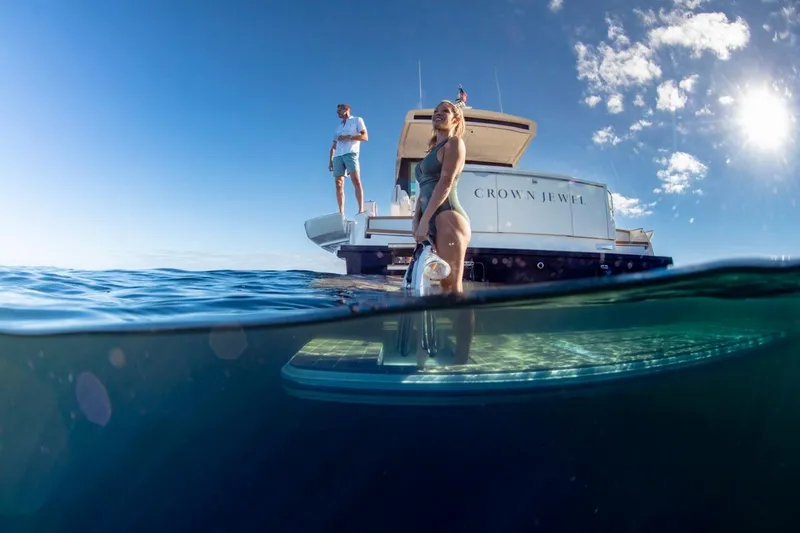 Slide: The Image of 2025 Tiara Yachts EX 60 on water, people enjoying sunny day, ocean view. - 17