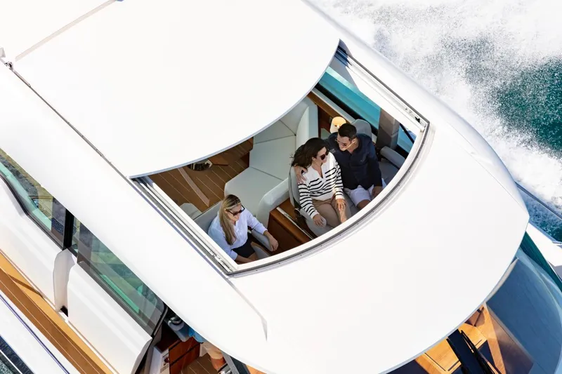 Slide: The Image of 2025 Tiara Yachts EX 60 with passengers enjoying the open deck. - 18