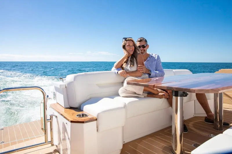 Slide: The Image of Couple enjoying a sunny day on a 2025 Tiara Yachts EX 60. - 20