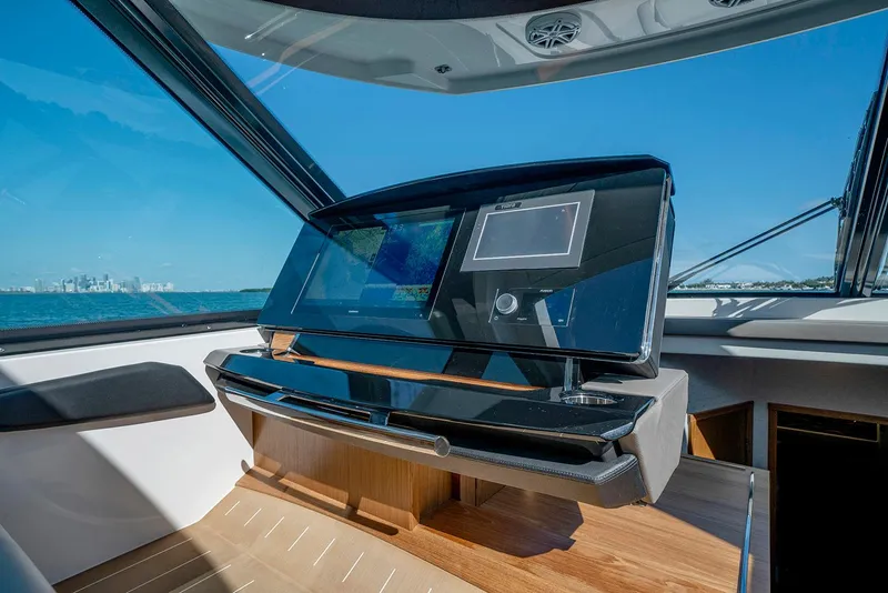Slide: The Image of 2025 Tiara Yachts EX 60 helm with advanced navigation system and ocean view. - 25