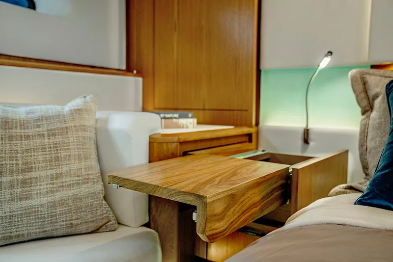 Slide: The Image of Luxurious interior of 2025 Tiara Yachts EX 60 with elegant wood finish and cozy seating. - 26