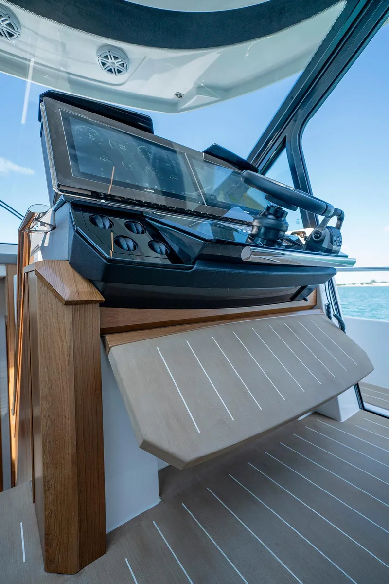 Slide: The Image of 2025 Tiara Yachts EX 60 helm station with modern controls and panoramic view. - 27