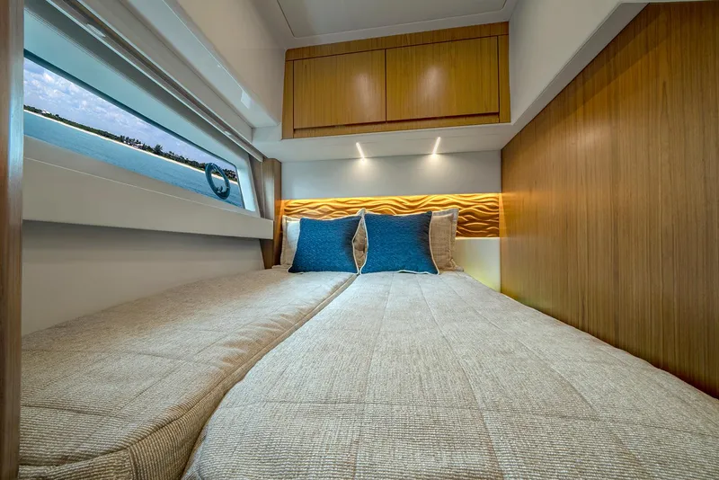 Slide: The Image of Luxurious cabin interior of 2025 Tiara Yachts EX 60 with modern design and cozy bedding. - 28