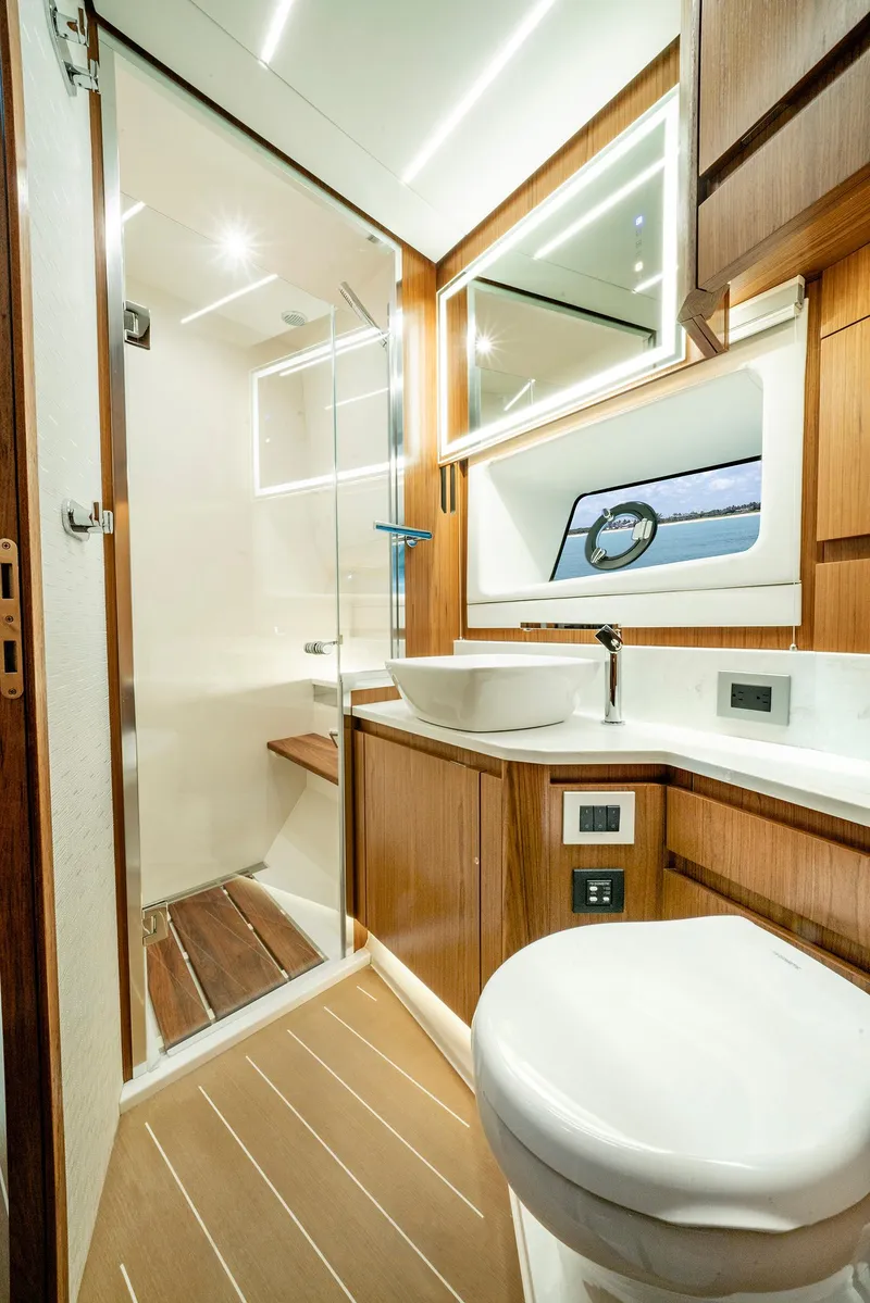 Slide: The Image of Luxurious bathroom in 2025 Tiara Yachts EX 60, featuring modern fixtures and elegant wood accents. - 29