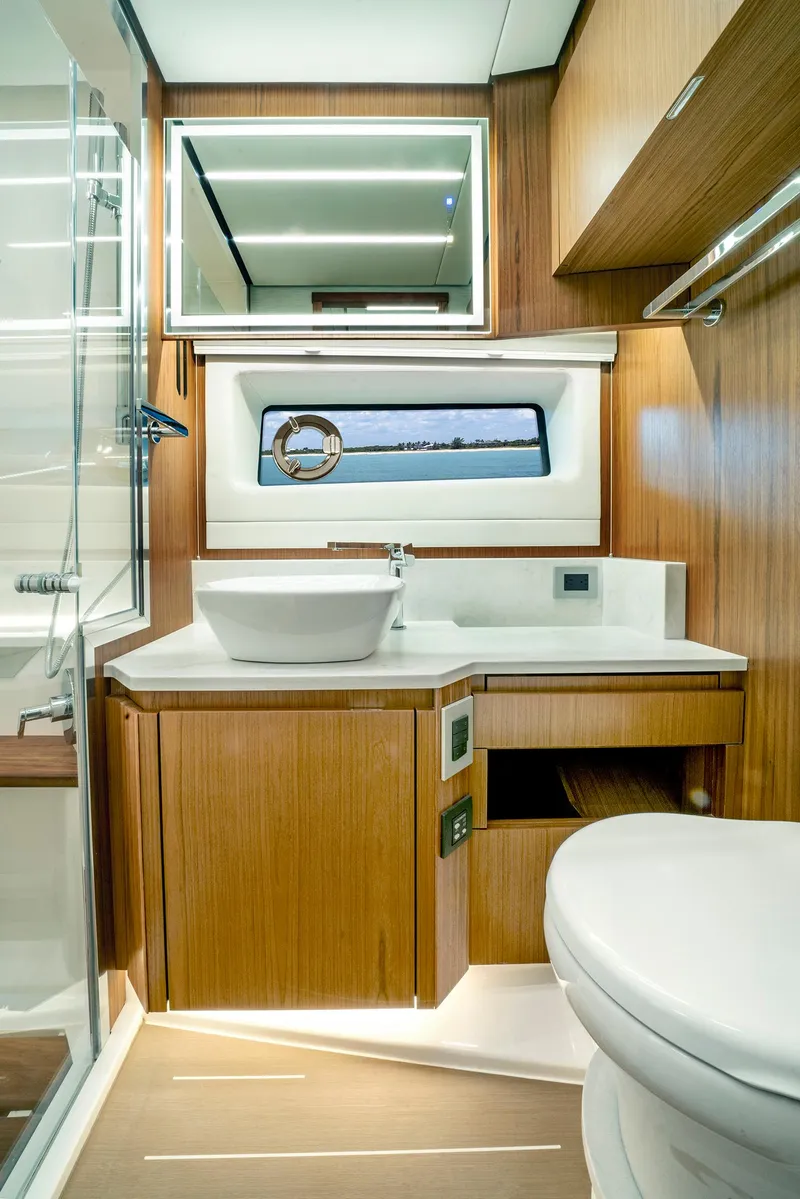 Slide: The Image of Luxurious 2025 Tiara Yachts EX 60 bathroom with modern fixtures and elegant wood finishes. - 30