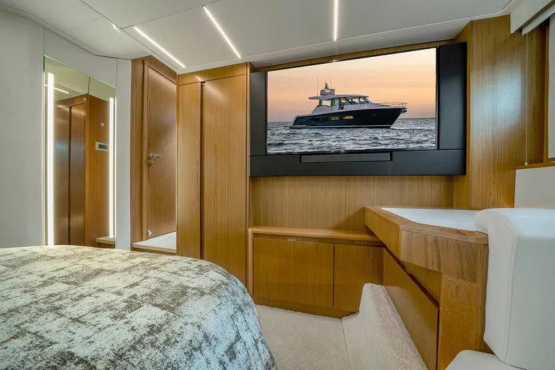 Slide: The Image of Luxurious 2025 Tiara Yachts EX 60 interior with modern wood finishes and large TV. - 38