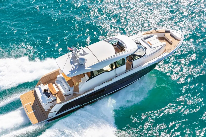 Slide: The Image of 2025 Tiara Yachts EX 60 cruising on vibrant blue ocean waters. - 4