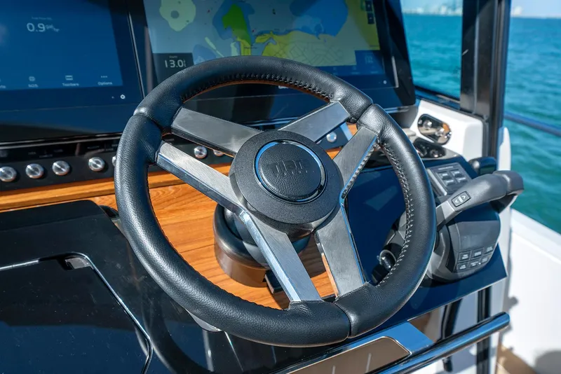 Slide: The Image of Steering wheel of 2025 Tiara Yachts EX 60 with navigation display. - 45