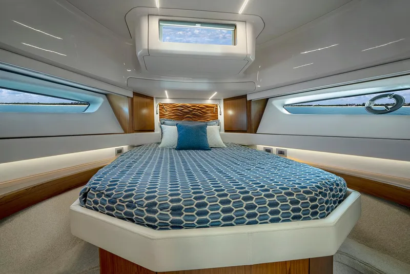 Slide: The Image of Luxurious 2025 Tiara Yachts EX 60 cabin interior with modern bedding and elegant design. - 47
