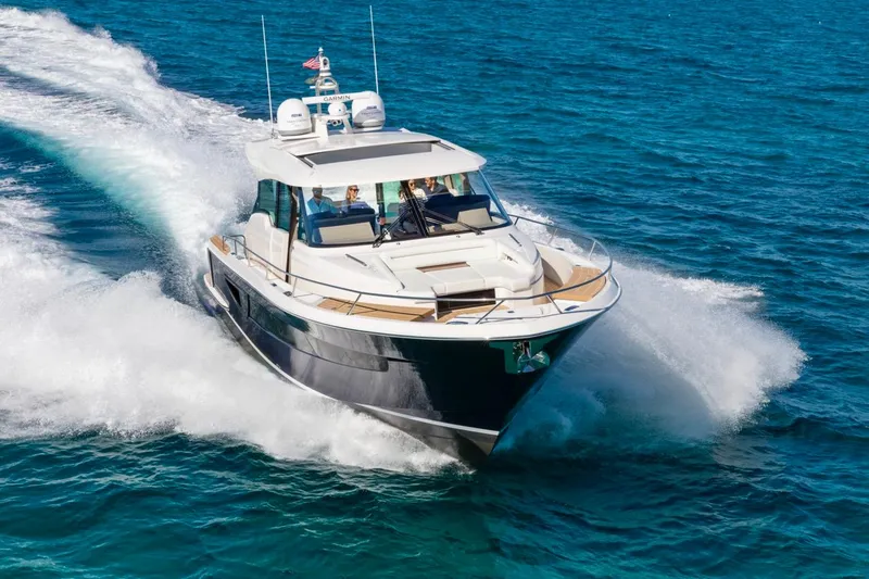 Slide: The Image of 2025 Tiara Yachts EX 60 cruising on open water. - 6