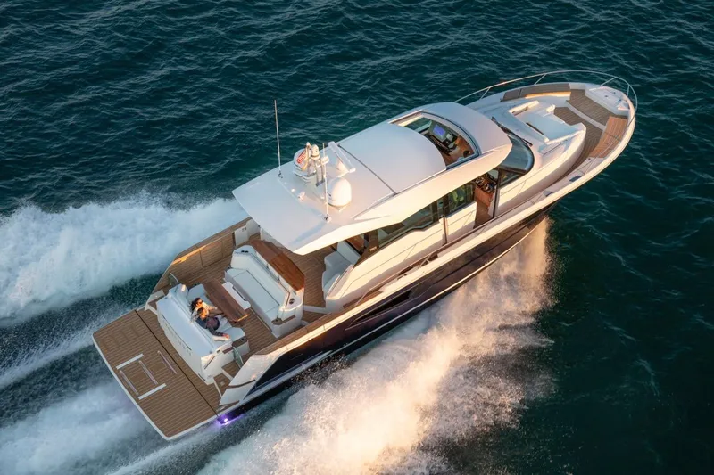 Slide: The Image of 2025 Tiara Yachts EX 60 cruising on open water, aerial view. - 7