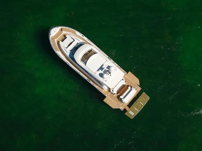 Slide: The Image of Aerial view of 2025 Tiara Yachts EX 60 luxury yacht on green water. - 8