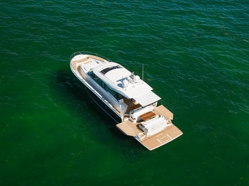 Slide: The Image of 2025 Tiara Yachts EX 60 luxury yacht on open water. - 9