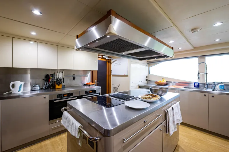 Slide: The Image of Luxurious kitchen interior on 2010 Sunseeker 40 Metre Yacht, featuring modern appliances and sleek design. - 13