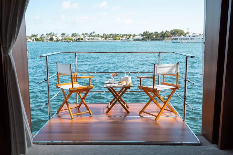 Slide: The Image of Sunny yacht deck with chairs and table overlooking serene water, Sunseeker 40 Metre Yacht 2010. - 16