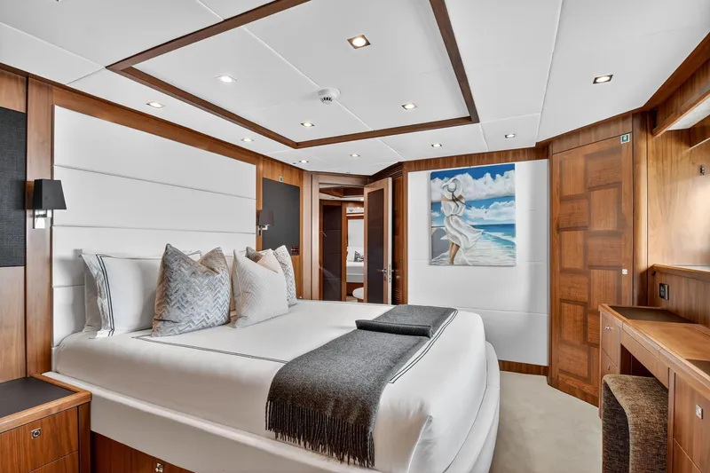 Slide: The Image of Luxurious bedroom interior on a 2010 Sunseeker 40 Metre Yacht, featuring elegant wood finishes. - 20