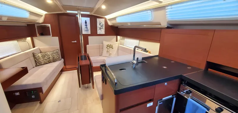 Slide: The Image of Luxurious interior of 2024 Hanse 388 yacht with modern kitchen and cozy seating area. - 13