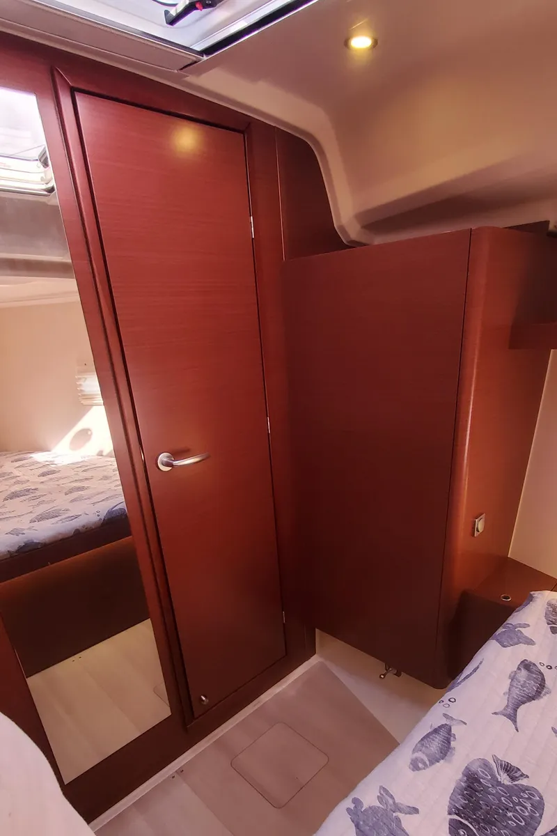 Slide: The Image of 2024 Hanse 388 yacht interior with wooden cabinetry and cozy bedding. - 18