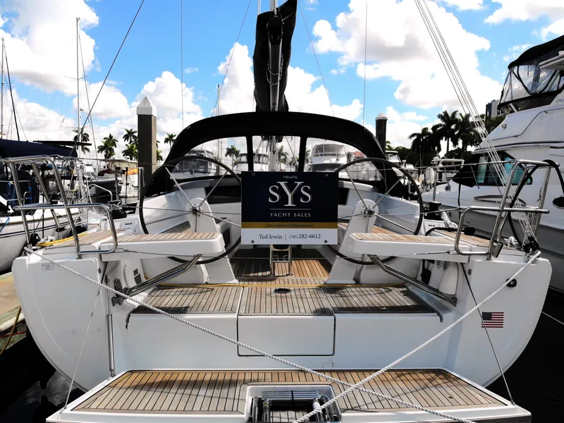 Slide: The Image of 2024 Hanse 388 yacht docked at marina, featuring spacious deck and elegant design. - 29