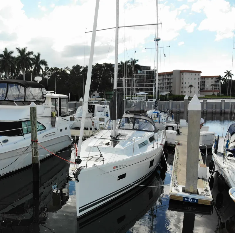 Slide: The Image of 2024 Hanse 388 yacht docked in marina, surrounded by other boats. - 30