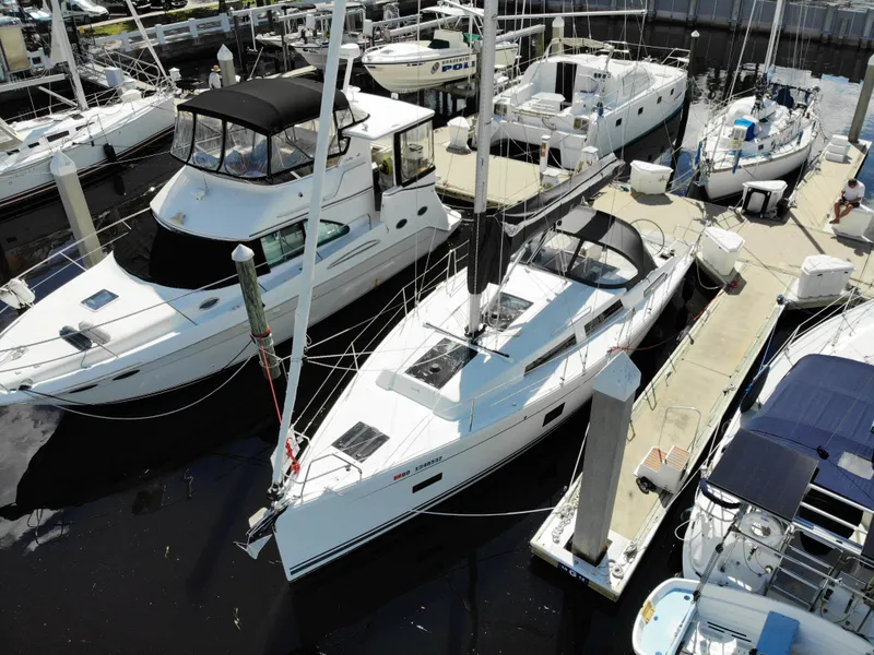 Slide: The Image of 2024 Hanse 388 yacht docked at marina, surrounded by other boats. - 35