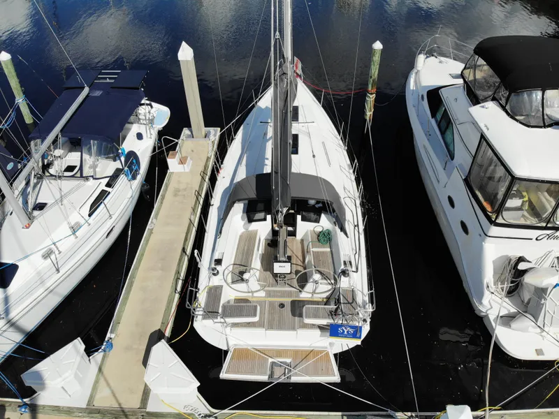 Slide: The Image of Aerial view of 2024 Hanse 388 sailboat docked between two other boats. - 37
