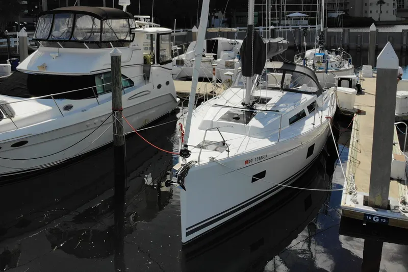 Slide: The Image of 2024 Hanse 388 sailboat docked at marina, alongside other boats. - 39