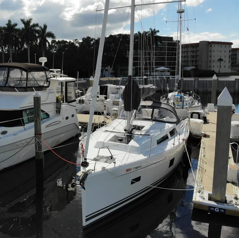 Slide: The Image of 2024 Hanse 388 sailboat docked at marina, surrounded by other boats. - 4