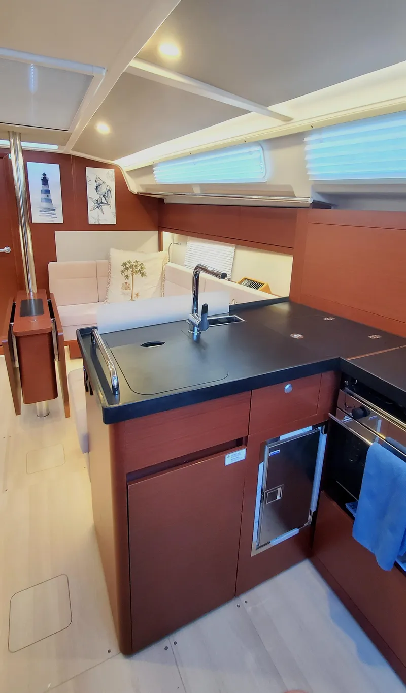Slide: The Image of 2024 Hanse 388 yacht interior with modern kitchen and cozy seating area. - 8