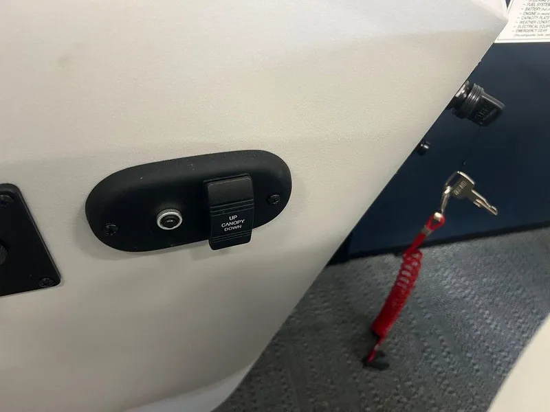 Slide: The Image of Control panel of 2025 Godfrey Sweetwater 2286 SB GTP boat with key and safety cord. - 11