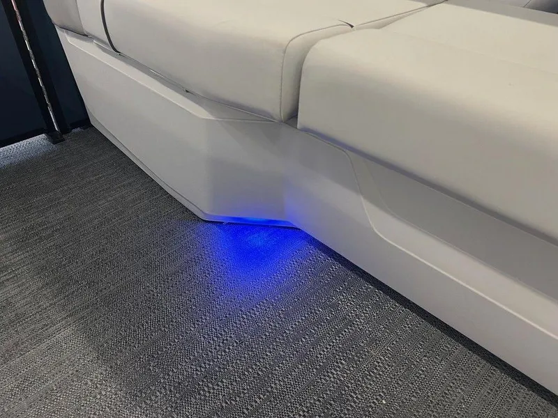 Slide: The Image of 2025 Godfrey Sweetwater 2286 SB boat interior with blue LED lighting under seat. - 16
