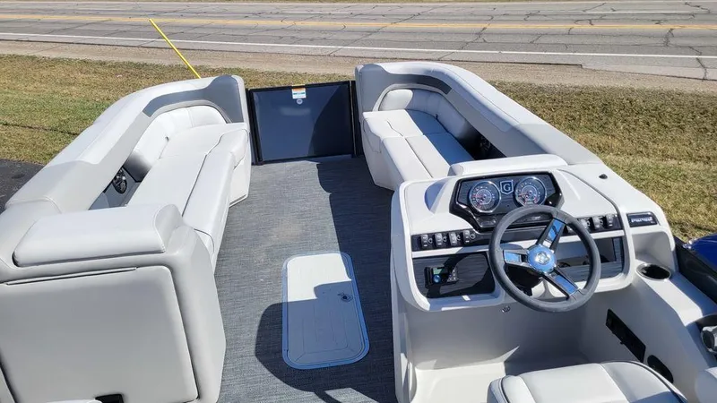 Slide: The Image of 2025 Godfrey Sweetwater 2286 SB GTP boat interior with plush seating and modern dashboard. - 9