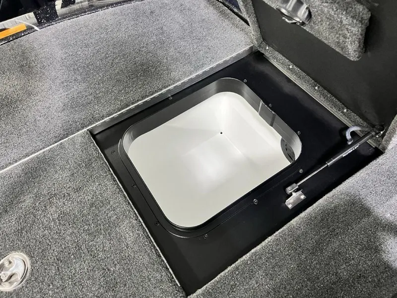 Slide: The Image of 2025 Skeeter FXR20 PRO boat storage compartment with open hatch. - 14